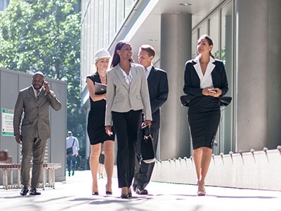 People Walking in front of building