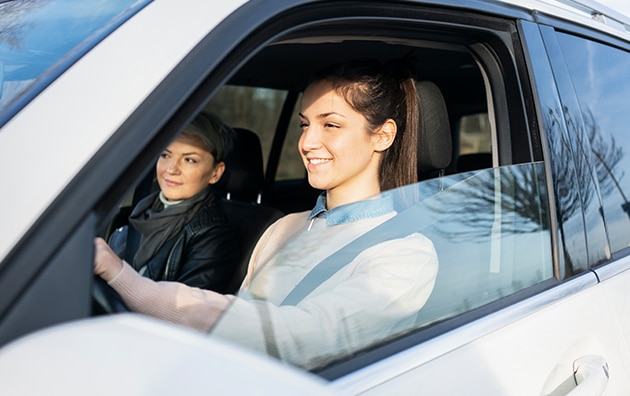 parent and teen riding in car