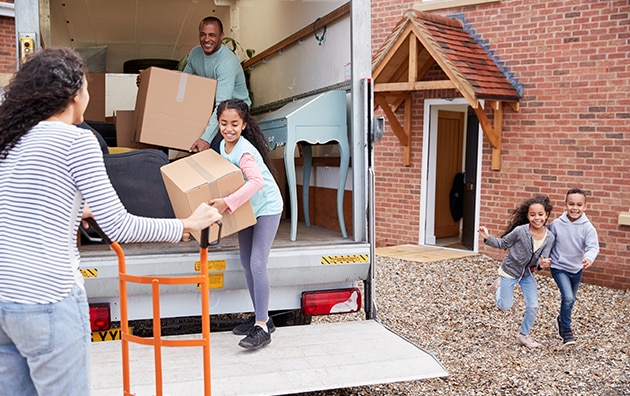 Family unpacking a moving truck