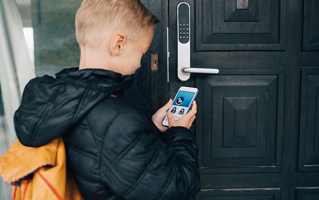 person unlocking their home using a smart phone