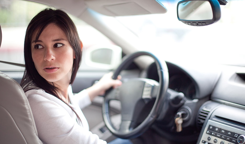 woman in car backing up