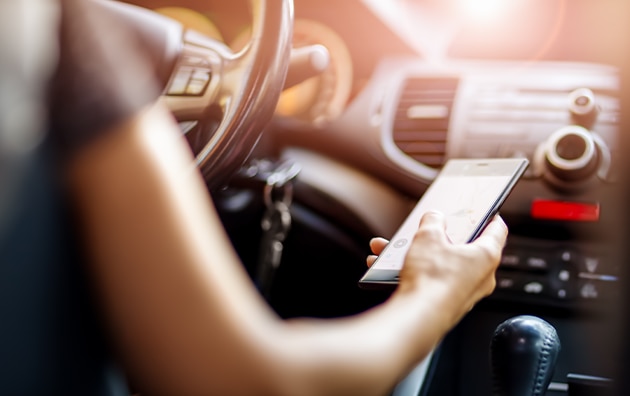 A person on their cell phone while driving