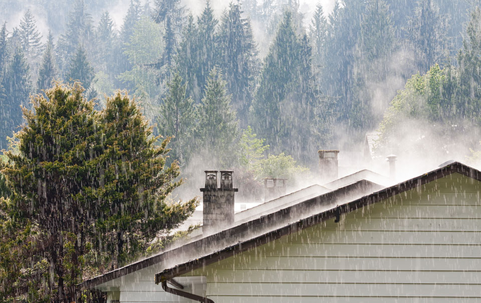 Rain hitting the roof on a house