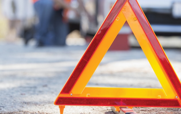 Triangle reflection on road in front of a truck accident