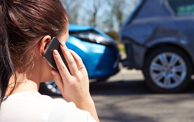 Woman on phone after a car accident