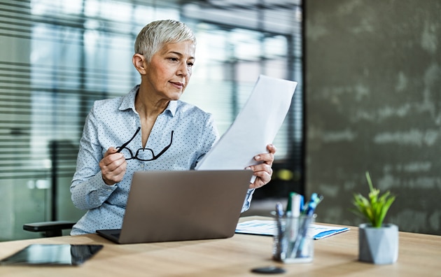 Woman looking at papers on a desk