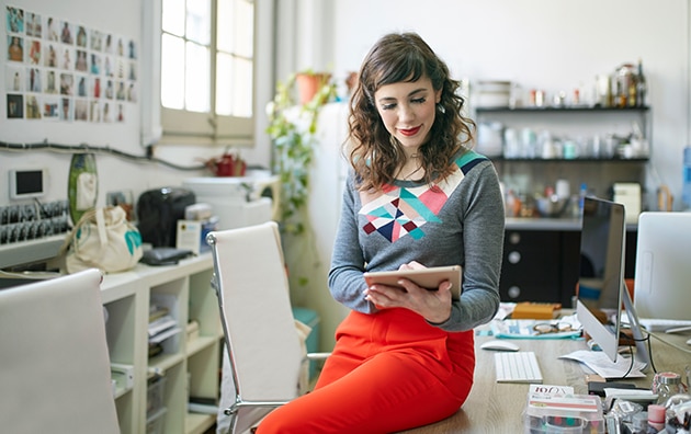 Small business owner looking at a device