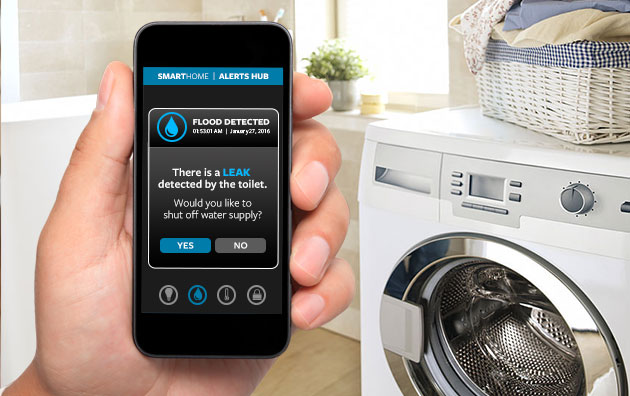 A hand holding a mobile phone detecting a laundry machine water leak.