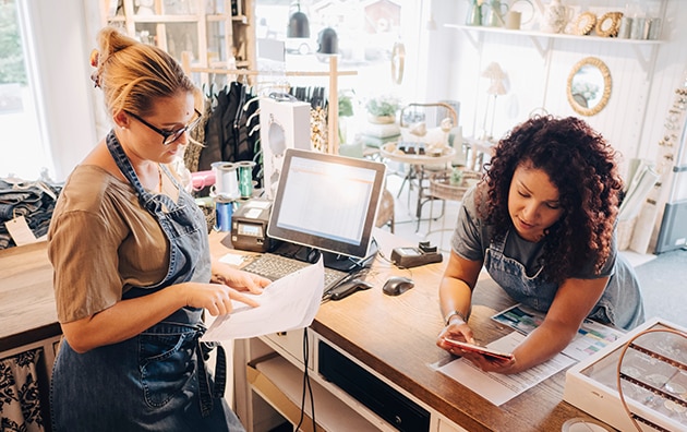 Two business owners looking at paperwork 