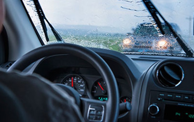 Person driving a car in the rain